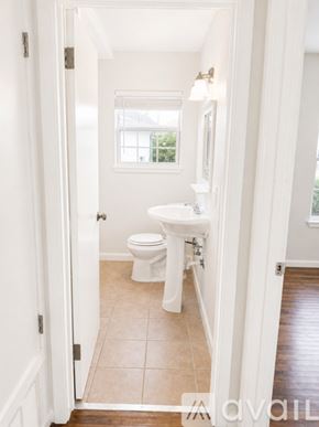 Corpus Christi apartment for rent - A room with a ceiling fan and wooden flooring.