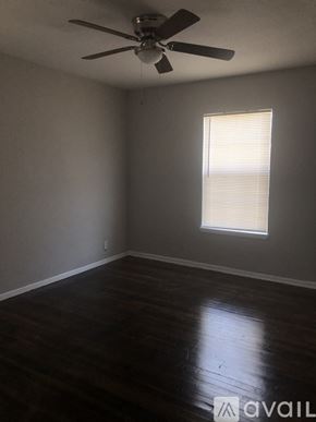 Corpus Christi apartment for rent - A room with a ceiling fan and a window with blinds.