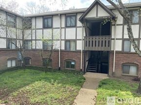 Nashville condo for rent - A building with a balcony and a tree in front of it.