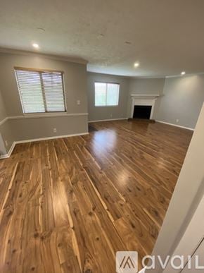 Nashville condo for rent - A spacious room with wooden flooring and a fireplace.