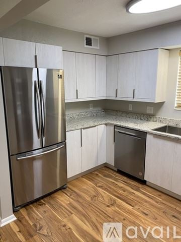 Nashville condo for rent - A kitchen with a stainless steel refrigerator and wooden flooring.