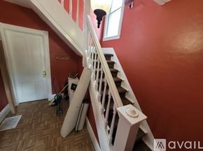 Lockport apartment for rent - A staircase with a red wall and a white door.