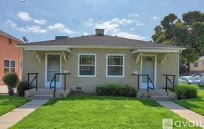 Burbank apartment for rent - A two-story house with a front porch and a well-maintained lawn.