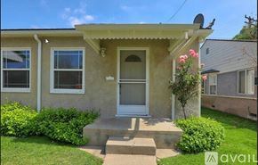 Burbank apartment for rent - A house with a red door and a green roof is for sale.