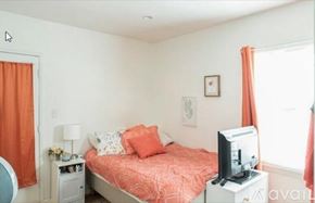 Burbank apartment for rent - A bedroom with a bed, nightstand, and television.