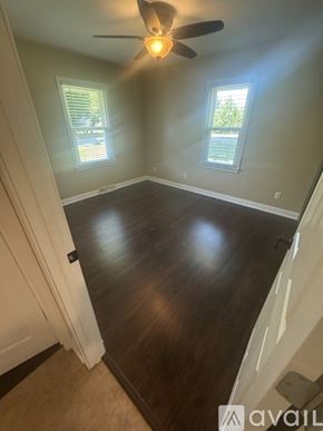 Holland house for rent - A room with a ceiling fan and two windows.