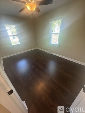 Holland house for rent - A room with a ceiling fan and two windows.