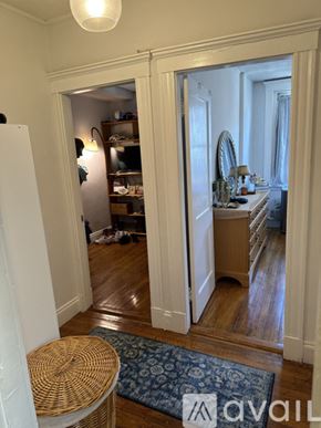 Boston apartment for rent - A room with a mirror and a dresser is visible through an open door.