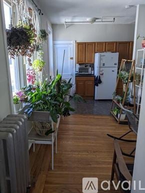 Boston apartment for rent - A kitchen with wooden floors and a white refrigerator.