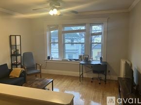 Boston apartment for rent - A living room with a couch, chair, and a desk with a computer.
