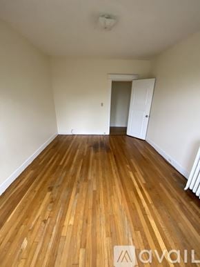 Boston apartment for rent - A room with wooden flooring and a white door.