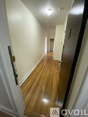 Boston apartment for rent - A hallway with wood floors and white walls.