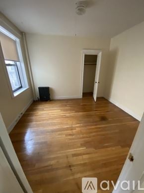 Boston apartment for rent - A room with wooden flooring and a window on the left side.