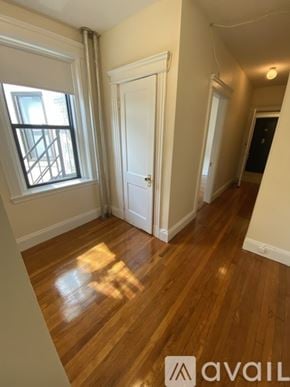 Boston apartment for rent - A room with wooden floors and a window.