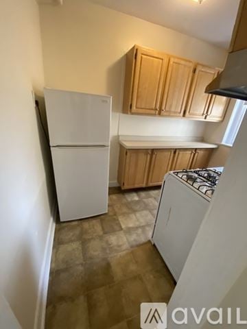 Boston apartment for rent - A kitchen with a white fridge and a white stove.