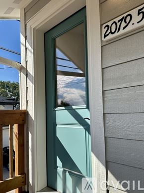 Denver house for rent - A door with a glass window and a number plate above it.