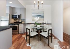 San Francisco condo for rent - A modern kitchen with a dining table set for two.