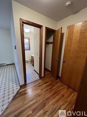 Danbury apartment for rent - A hallway with a wooden floor and a checkered tile floor.