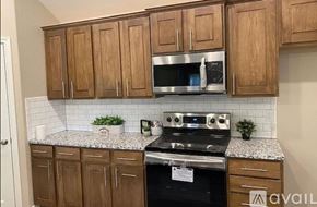San Angelo house for rent - A kitchen with wooden cabinets and a granite countertop.