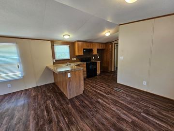 Norman house for rent - A kitchen area with wooden flooring and a countertop.