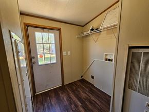 Norman house for rent - A room with a door and a window.