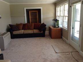 Warrenton apartment for rent - A living room with a couch, a fish tank, and a window.