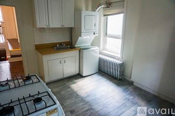 Philadelphia apartment for rent - A kitchen with a white stove and a white refrigerator.