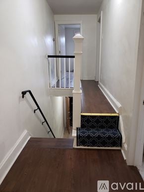 Philadelphia apartment for rent - A hallway with a black and white patterned staircase.