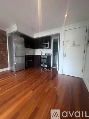 New York apartment for rent - A kitchen with wooden floors and a brick wall.