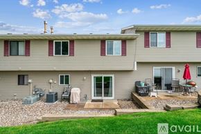 Eagan apartment for rent - A house with a patio and a red umbrella.