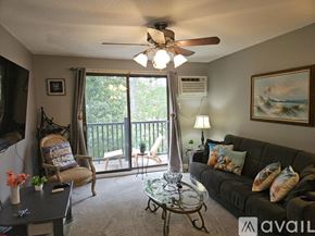 Taunton condo for rent - A living room with a couch, chairs, and a ceiling fan.