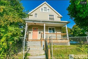 Rochester apartment for rent - A two-story house with a red door and a balcony.