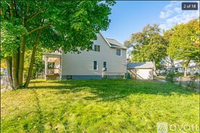 Rochester apartment for rent - A house with a white exterior and a green lawn in front.