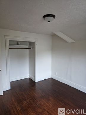Rochester apartment for rent - A room with a white ceiling and wooden floor.