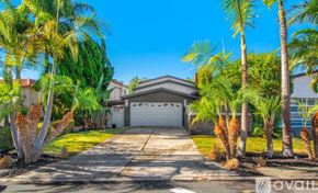 Dana Point house for rent - A house with a driveway and palm trees in front.