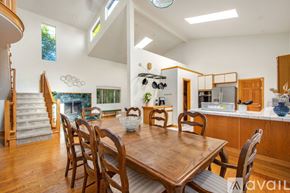 Dana Point house for rent - A dining room with a wooden table and chairs.