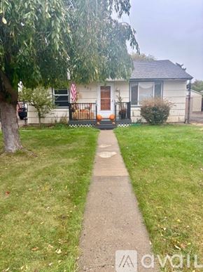 Ellensburg house for rent - A white house with a flag on the front porch.