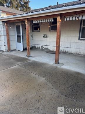 Ellensburg house for rent - A house with a white exterior and a porch with a wooden column.