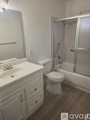 Roseville apartment for rent - A bathroom with a toilet, sink, and shower.