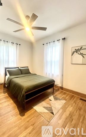 Kingsport house for rent - A bedroom with a bed, a ceiling fan, and a rug.