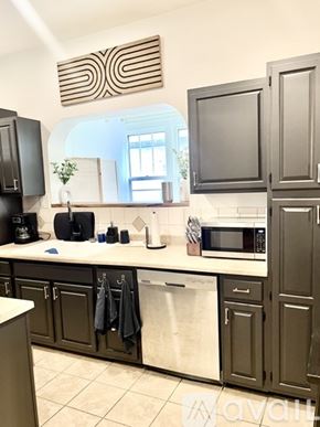 Kingsport house for rent - A kitchen with dark brown cabinets and a white counter.