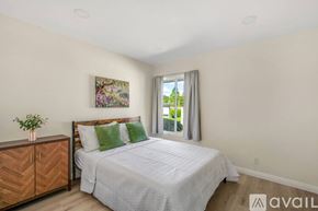Aliso Viejo house for rent - A bedroom with a large bed and a wooden cabinet.