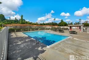 Aliso Viejo house for rent - A pool surrounded by a fence with a mountain in the background.