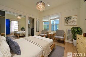 Los Angeles apartment for rent - A balcony with white railings overlooks a row of buildings.
