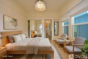 Los Angeles apartment for rent - A room with wooden floors and white walls, with a sliding glass door leading to a balcony.