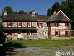 Media house for rent - A house with a stone foundation and a wooden exterior is shown.