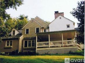 Media house for rent - A house with a white chimney is surrounded by a white picket fence.