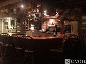 Media house for rent - A kitchen with a table and chairs in front of a brick wall.