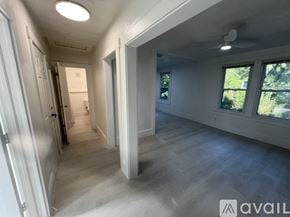 St. Augustine apartment for rent - A long hallway with a door on the left and a window on the right.