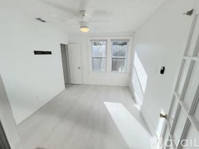 St. Augustine apartment for rent - A spacious room with white walls and a large window overlooking greenery.
